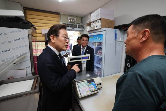 이재명 대통령이 13일 경기도 연천군 청산면의 한 정육점에 방문해 농촌 기본소득 시범사업의 효과를 묻고 있다. 연합뉴스