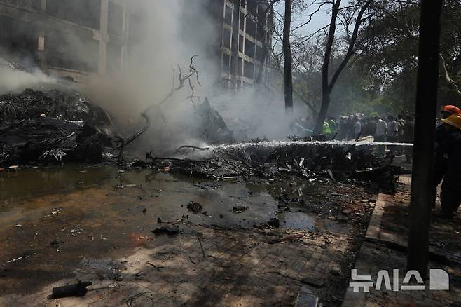 <font style="vertical-align: inherit;"><font style="vertical-align: inherit;">[아마다바드=AP/뉴시스] 12일(현지 시간) 인도 구자라트주 아마다바드에서 발생한 여객기 추락 사고 현장에서 소방대원들이 화재 진압을 하고 있다. 이날 오후 아마다바드 공항에서 이륙한 영국행 에어인디아 AI171편 여객기가 추락해 탑승자 242명 가운데 1명을 제외한 전원이 숨졌으며, 추락 현장의 학생 등 약 50명도 사망한 것으로 전해졌다. 2025.06.13.</font></font>