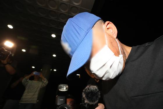 The suspect who murdered a woman he had been stalking in Daegu is escorted to Seongseo Police Precinct in Daegu on June 15. [NEWS1]