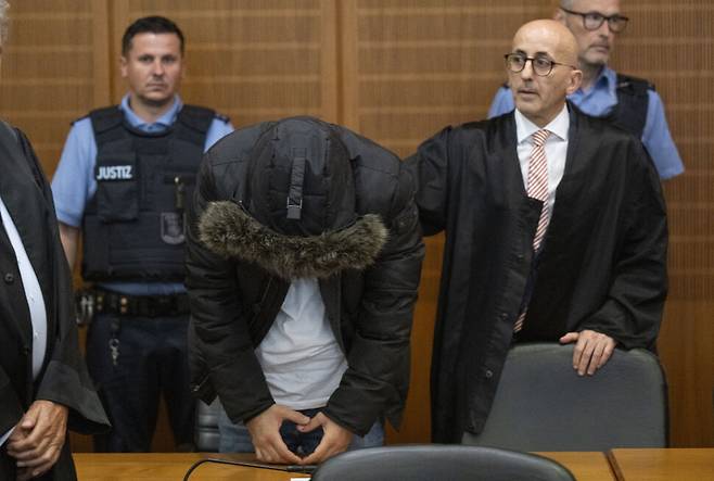 시리아 의사 알라 무사(가운데)가 그의 변호사 오사마 알아기(오른쪽)와 함께 16일(현지시각) 독일 프랑크푸르트 고등법원 법정에 섰다. 사진 DPA AP 연합뉴스