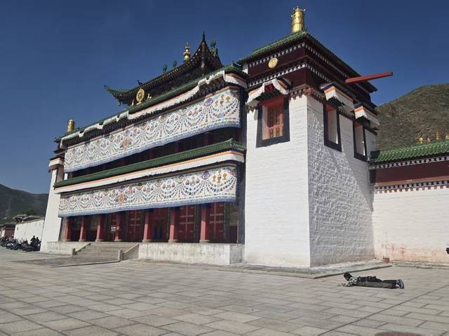 티베트 불교 교육의 핵심 기관 중 한 곳인 라브랑사에서 한 순례객이 오체투지를 하고 있다.