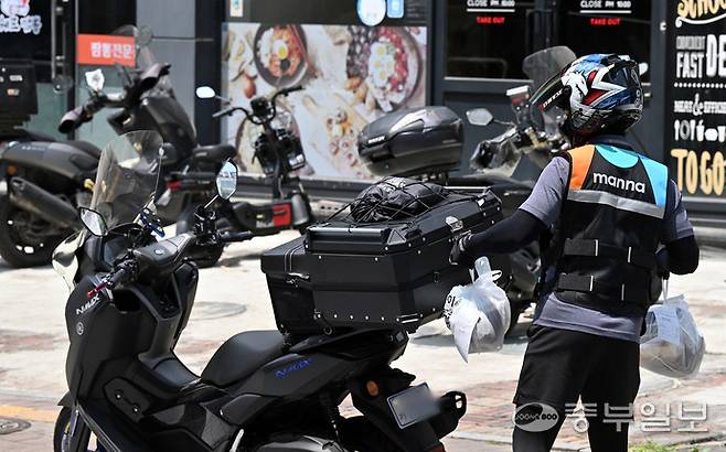 수원시 팔달구 한 배달 전문매장 앞에서 배달라이더가 포장 음식을 옮기고 있다. 김경민기자