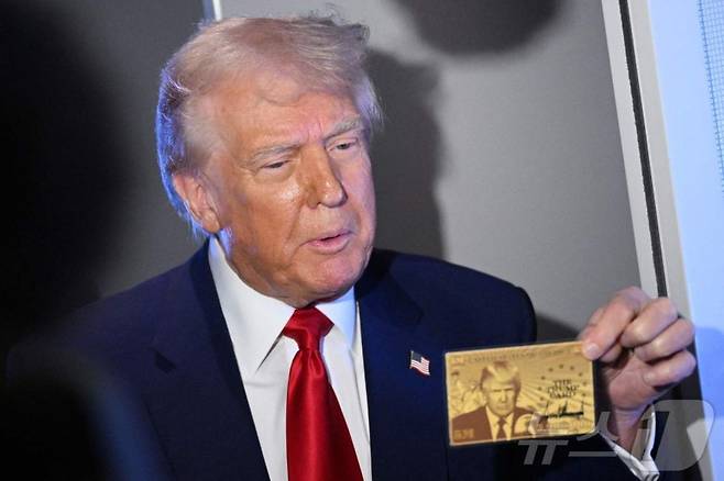 도널드 트럼프 미국 대통령이 3일(현지시간) 플로리다주 마이애미로 이동하는 기내에서 취재진과 만나 골드 카드를 들고 "500만달러(약 71억원)를 내면 미국 영주권을 주는 '골드카드' 가 2주 내에 출시될 것이다＂고 말하고 있다. 2025.04.04 /AFPBBNews=뉴스1