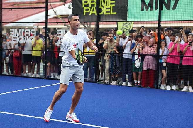 Portuguese football star Cristiano Ronaldo, known as a padel enthusiast, plays the sport in Singapore in 2023. /AFP