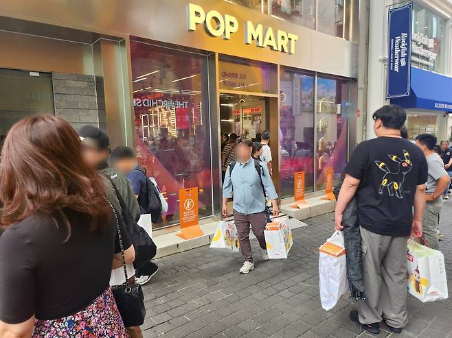 22일 오전 11시쯤 서울 중구 명동에 위치한 팝마트. 오픈런에 성공한 중국인 리셀러들이 양손에 제품을 들고 가게 바깥으로 나왔다. 이 아트토이들은 보통 중국에서 재판매된다. /김관래 기자
