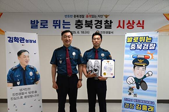 김학관(왼쪽) 충북경찰청장이 18일 진천경찰서에서 김홍래 경장에게 발로 뛰는 충북경찰 표창장과 함께 운동화를 전달한 뒤 기념 사진을 찍고 있다. [사진=진천경찰서]