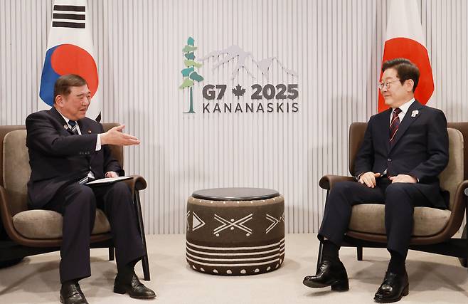 President Lee Jae Myung, right, sits with Japanese Prime Minister Shigeru Ishiba for their first bilateral talks on the margins of the G7 summit in Kananaskis, Canada, on June 17. [JOINT PRESS CORPS]