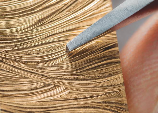 물결 무늬를 수공으로 새겨 브레이슬릿 링크의 이음새가 보이지 않는다. 장인의 숙련된 손기술이 필요하다. 사진 피아제