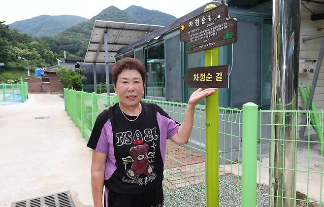 충북 괴산군 청천면 사담1리 마을&nbsp;길 입구에 놓은 ‘차정순 길’ 푯말 앞에서 차정순씨가 길을 소개하고 있다. 괴산군 제공&nbsp;&nbsp;
