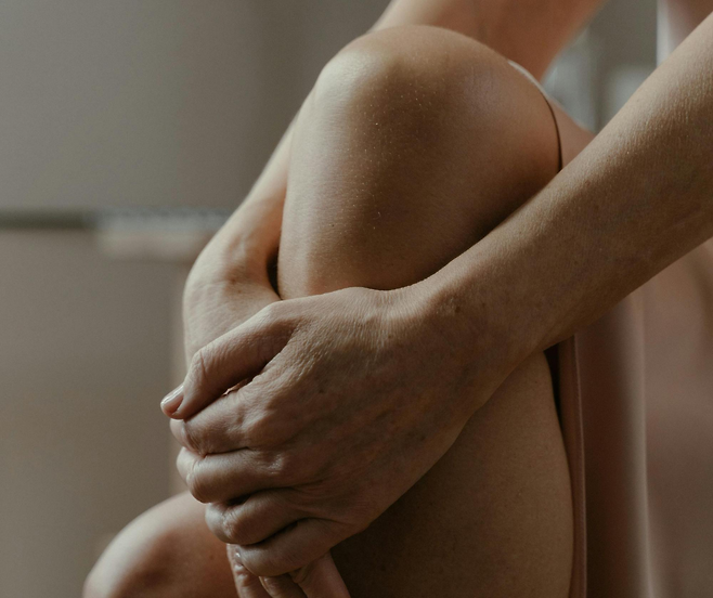 무릎을 감싸고 있는 양손