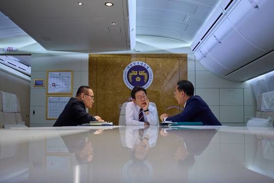 이재명 대통령 지난 16일 주요 7개국(G7) 정상회의 참석을 위해 캐나다로 향하는 공군1호기 안에서 위성락 국가안보실장 등 참모들과 회의를 하고 있다. 사진공동취재단