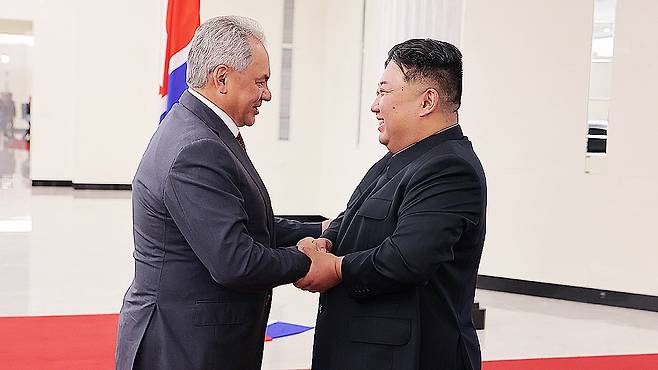 North Korean leader Kim Jong-un, right, meets with Russian Security Council Secretary Sergei Shoigu on June 17. According to state media, the two confirmed areas of cooperation under their treaty framework. [YONHAP]