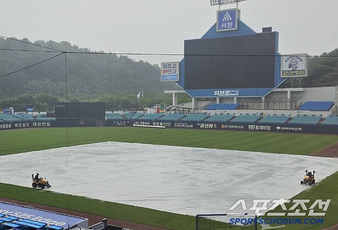 한화-삼성전이 예정돼 있는 24일 대구 삼성라이온즈파크에 비가 내리고 있어 대형 방수포가 깔려있다. 대구=권인하 기자