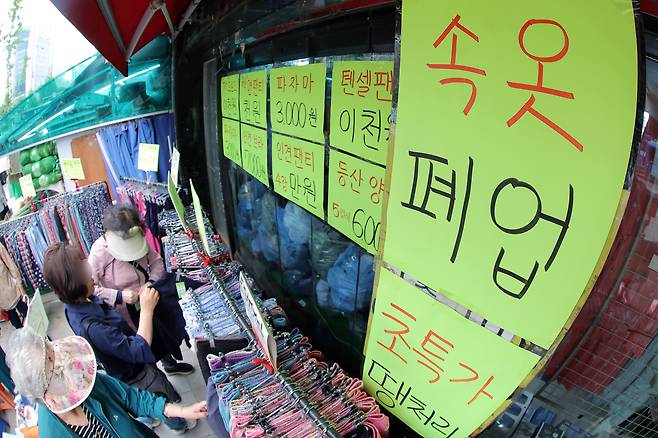 서울 서대문구 홍제동의 '속옷 폐업'을 붙인 가게에서 주민 등이 물건을 고르고 있다. /뉴스1