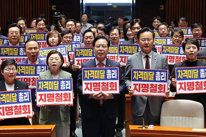 국민의힘 송언석 원내대표를 비롯한 의원들이 26일 이재명 대통령의 첫 시정연설이 끝난 직후 서울 여의도 국회 예결위회의장에서 김민석 국무총리 후보자의 지명 철회를 촉구하며 구호를 외치고 있다.(사진=연합뉴스)