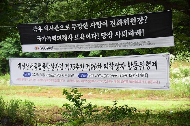 박선영 진실화해위원장이 대전 산내 골령골을 방문한 25일, 27일 추도식을 알리는 펼침막과 박 위원장을 비판하는 펼침막이 함께 붙어 있다. 대전 골령골 대책회의 제공
