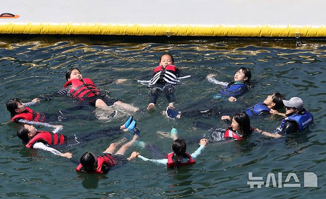 [부산=뉴시스] 하경민 기자 = '2025년 초등학생 바다생존수영 교육과정'이 열린 26일 부산 영도구 한국해양대학교 해상교육장에서 초등학생들이 바다 생존 수영법을 배우고 있다. 한국해양대는 오는 7월18일까지 영도구 내 초등학교 26곳의 6학년 학생 1520명을 대상으로 이 교육과정을 운영한다. 2025.06.26. yulnetphoto@newsis.com