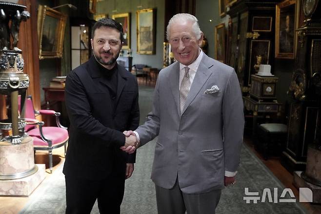 [윈저=AP/뉴시스] 볼로디미르 젤렌스키(왼쪽) 우크라이나 대통령이 23일(현지 시간) 영국 윈저성에서 찰스 3세 국왕과 비공개 면담을 하면서 악수하고 있다. 이날 젤렌스키 대통령은 평소의 군복 대신 검은색 재킷을 입었다. 2025.06.24.