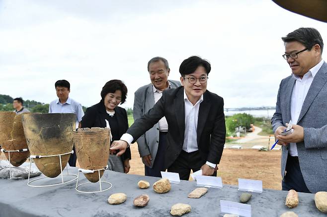 지난 26일 김포시 대곶면 신안리 신석기 유적 현장 공개행사에 참석한 김병수 시장이 관계자들과 발굴된 유물을 둘러보고 있다. 사진=김포시
