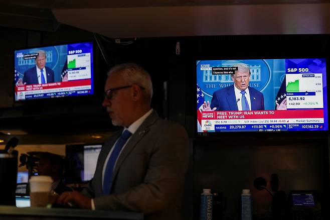 27일 미국 뉴욕증권거래소(NYSE)에서 도널드 트럼프 미국 대통령의 뉴스가 화면에 표시되고 있다. /로이터 연합뉴스
