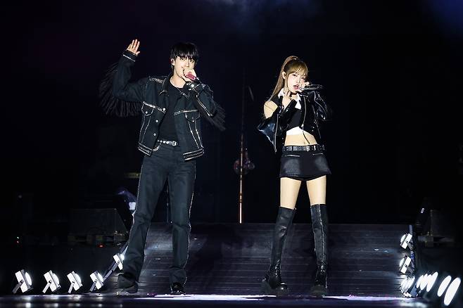BTS member Jin, left, performs on stage with singer Yena during his first solo fan concert ″#RunSeokJin_EP.Tour″ at the Goyang Sports Complex Auxiliary Stadium in Gyeonggi on June 28. [BIGHIT MUSIC]