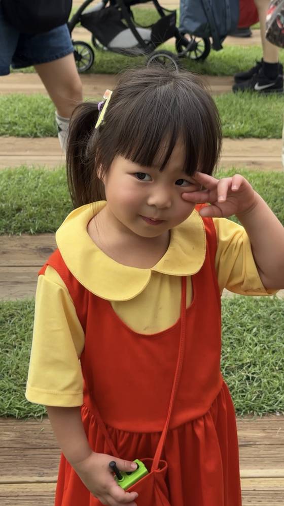 Xariel, 4, dressed as Young-hee from Netflix's ″Squid Game″ (2021-) pose for a photo at the show's grand finale event held at Seoul Plaza in central Seoul on June 28. [DANIELA GONZALEZ PEREZ]