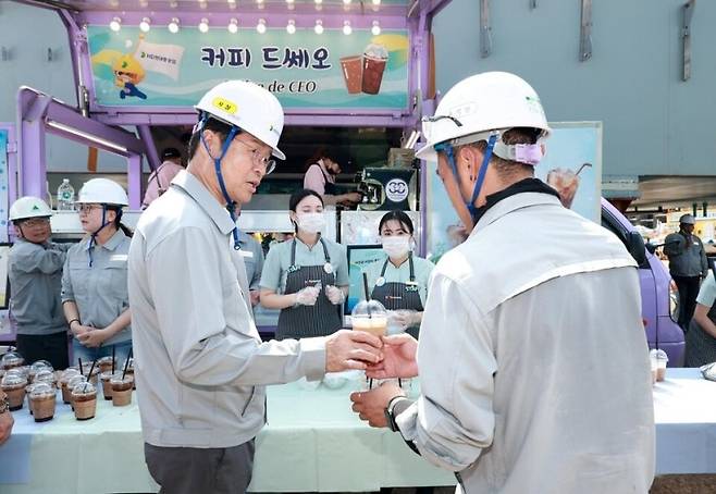 이상균 HD현대중공업 사장(앞줄 왼쪽 첫번째)이 지난해 8월, 울산 본사 직원들에게 혹서기 극복을 위해 시원한 커피를 나눠주며 격려하고 있다. HD현대중공업 제공