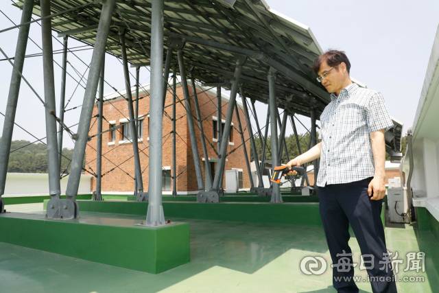 계명대 성서캠퍼스 오산관 옥상에 설치된 태양광 집광판 그늘 아래서 김해동 교수가 바닥 온도를 측정하고 있다. 우태욱 기자 woo@msnet.co.kr