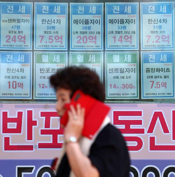 서울 시내의 한 부동산에 붙은 전세 매물 안내문 앞으로 시민이 지나고 있다. [사진=연합뉴스]