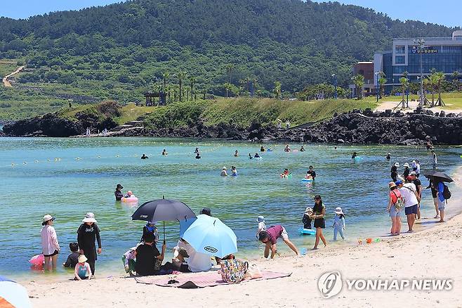 여름엔 바다가 최고 (제주=연합뉴스) 전지혜 기자 = 제주도 동부에 폭염경보, 북부와 중산간에 폭염주의보가 내려진 29일 제주시 조천읍 함덕해수욕장에서 피서객들이 물놀이하거나 바닷바람을 쐬며 여름 정취를 즐기고 있다. 2025.6.29 atoz@yna.co.kr
