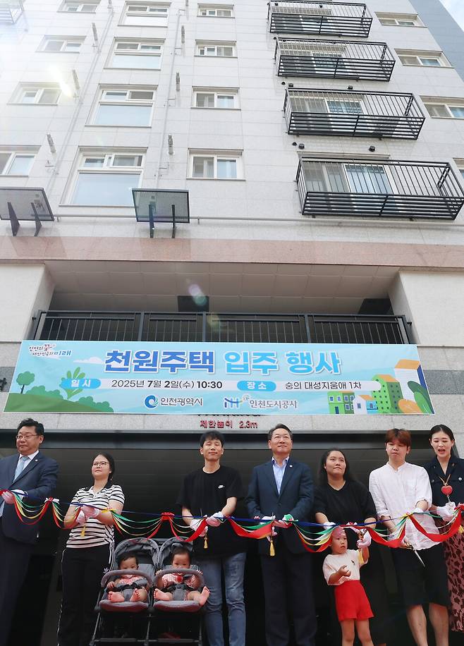 ▲&nbsp;2일 인천 미추홀구 숭의동의 천원주택(매입임대주택) 입주행사에서 유정복(가운데) 인천시장과 주형환(왼쪽) 저출산고령사회위원회 부위원장 및 입주자 가족과 내빈들이 테이프커팅을 하고 있다. /이재민 기자 leejm@incheonilbo.com