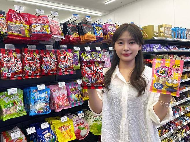 모델이 GS25에서 '젼언니 스윗믹스젤리 콜라맛'과 '스윗믹스젤리 미니언즈' 제품을 소개하고 있다.ⓒGS25
