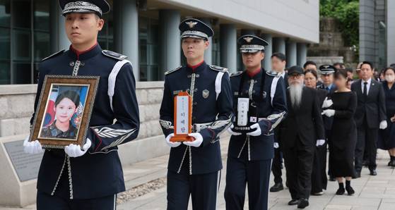 The portrait and remains of late Air Force Master Sgt. Lee Ye-ram are carried to a memorial hall during an enshrinement ceremony at Seoul National Cemetery in Dongjak District, southern Seoul, on July 20, 2024. [YONHAP]