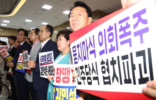 송언석 국민의힘 비상대책위원장 겸 원내대표를 비롯한 의원들이 본회의가 열린 3일 오후 서울 여의도 국회 로텐더홀에서 김민석 국무총리 후보자 임명동의안 표결에 불참한 뒤 규탄 피켓을 들고 있다. 뉴스1