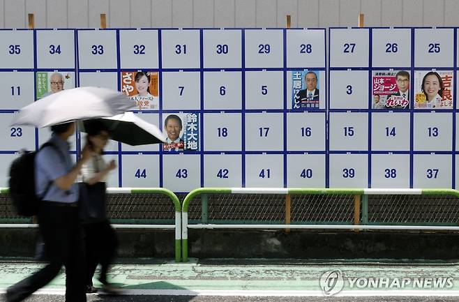 도쿄에 마련된 참의원 선거 게시판 (도쿄 EPA=연합뉴스) 일본에서 3일 참의원(상원) 선거전이 시작된 가운데 도쿄 선거 게시판 앞을 사람들이 지나가고 있다.