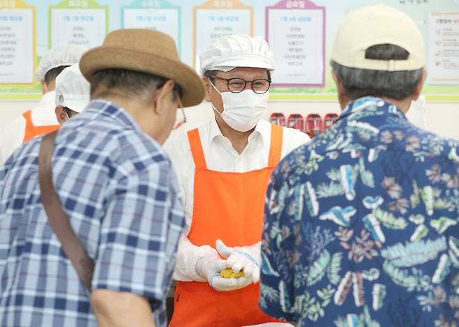 김홍규 강릉시장이 4일 강릉노인종합복지관에서 배식봉사를 하며 주민들과 이야기를 하고 있다. 강릉시 제공