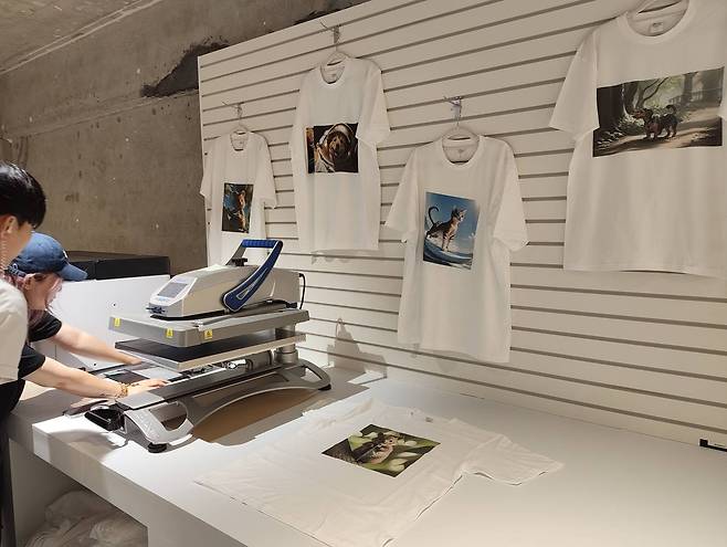 사전 신청한 방문객이 디자인한 티셔츠를 인쇄하고 있다 / 출처=IT동아)