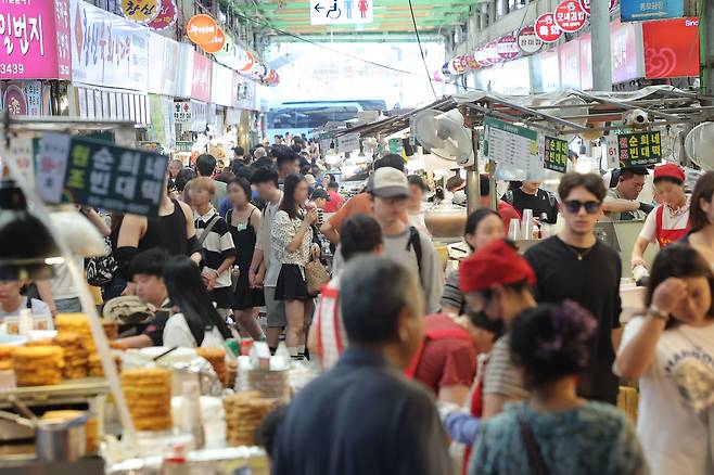 정부가 민생회복 소비쿠폰 1차 지급계획을 발표한 6일 서울의 한 전통시장을 찾은 시민들이 점포를 둘러보고 있다. [연합]