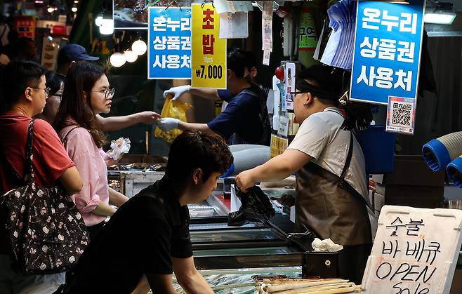 국회가 2차 추가경정예산안 처리를 앞둔 지난 4일 서울 마포구 망원시장에 온누리 상품권 사용 안내문이 게시돼 있다. 뉴스1