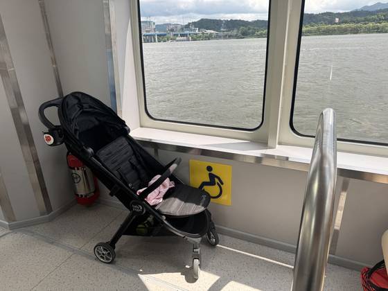 A stroller rests in the wheelchair area on the Hangang Bus on July 1. [CHO JUNG-WOO]