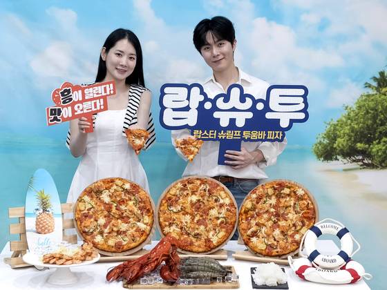 Models pose with the Domino Pizza's new summer menu, the Lobster Shrimp Toowoomba Pizza. [DOMINO PIZZA]