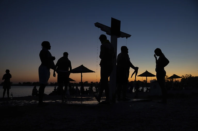 지난 6일(현지시간) 그리스에서 샤워하는 사람들. [사진 = AP]