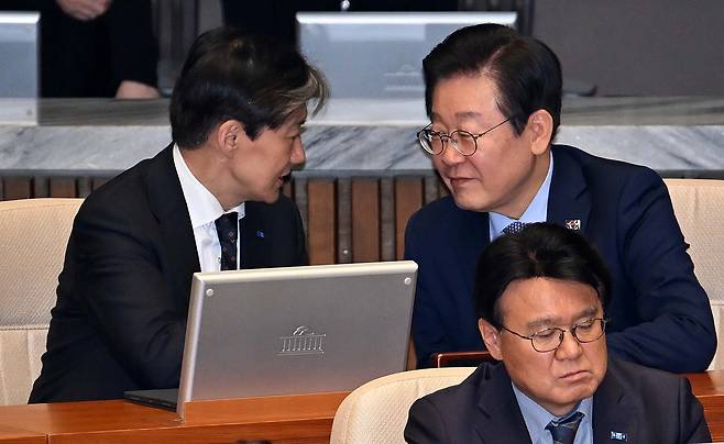 이재명(뒷줄 오른쪽) 대통령과 조국(뒷줄 왼쪽) 전 조국혁신당 대표. 사진은 지난해 11월 28일 더불어민주당 당대표였던 이 대통령과 조국혁신당 당대표였던 조 전 대표가 국회 본회의에서 대화하는 모습. 이 대통령 앞에 앉은 이는 황운하 조국혁신당 의원. 이상섭 기자.