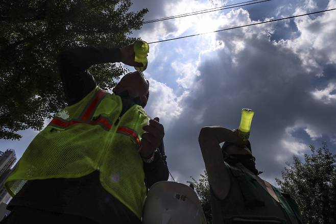 음료 마시는 건설 노동자들 - 연일 폭염이 지속되는 가운데 9일 서울 시내의 한 건설현장 노동자가 더위를 식히기 위해 이온음료를 마시고 있다. 2025.07.09.뉴시스