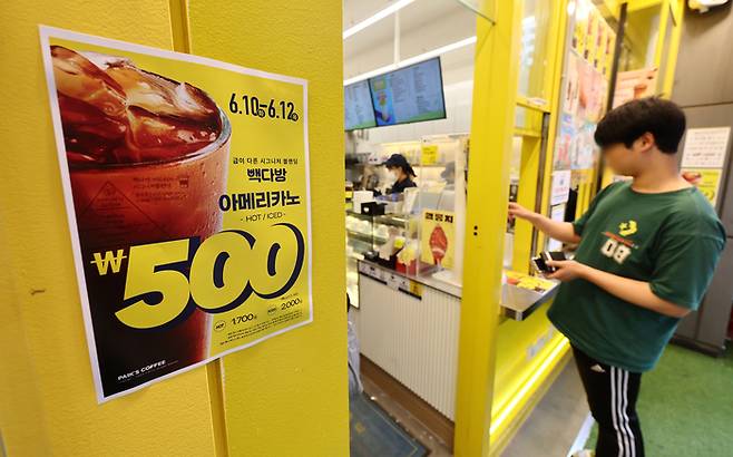 더본코리아의 커피전문점 빽다방이 아이스 아메리카노와 핫 아메리카노를 500원에 판매하는 할인 행사를 시작한 지난달 10일 서울 시내의 한 빽다방 매장 앞에 할인 안내문이 붙어있다. [사진 = 연합뉴스]