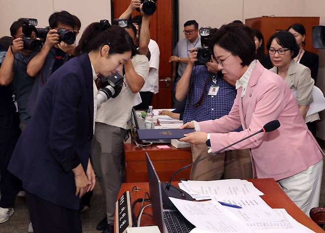강선우 여성가족부 장관 후보자가 14일 국회 여성가족위원회에서 열린 인사청문회에서 선서한 뒤 국민의힘 소속 이인선 위원장에게 선서문을 전달한 뒤 인사하고 있다. [연합]