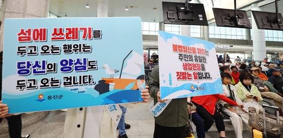 인천 옹진군 공무원들이 인천항 연안여객터미널에서 섬 관광객을 상대로 ‘쓰레기 되가져오기’ 등 캠페인을 벌이고 있다. [연합뉴스]