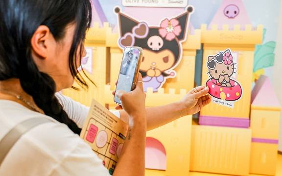 올리브영 홍대 매장에서 한 고객이 산리오 캐릭터 굿즈를 촬영하고 있다. CJ올리브영 제공