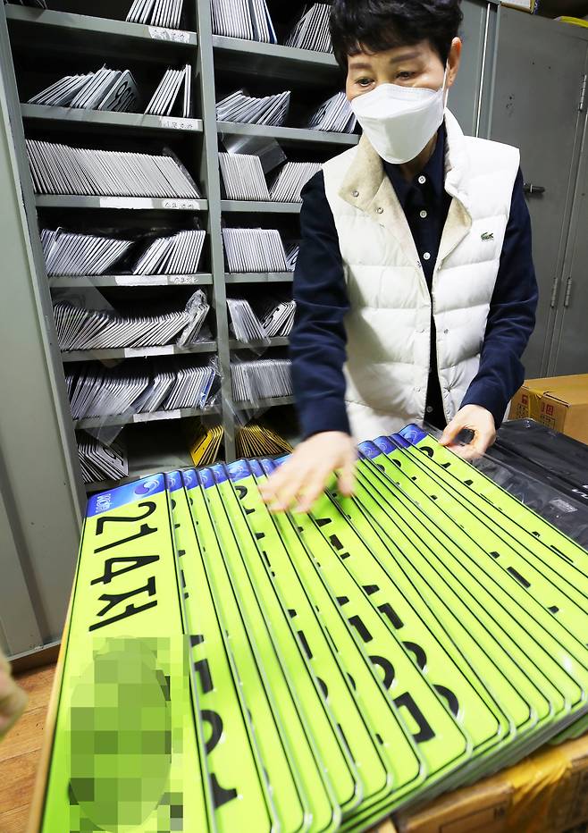 지난해 1월 광주광역시 북구 자동차번호판 교부소에서 담당자가 고액 법인차량용 연두색 번호판을 정리하고 있다. 지난해부터 8000만원 이상의 신규 등록 법인 차량은 연두색 번호판을 부착해야 한다./김영근 기자