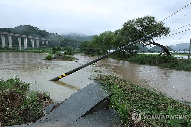 집중호우에 위태롭게 고립된 공주 사곡면 (공주=연합뉴스) 강수환 기자 = 17일 오후 호우특보가 내려진 충남 공주시 사곡면에서 한 도로가 무너져 내렸고 전봇대가 위태롭게 쓰러져 있다. 2025.7.17 swan@yna.co.kr